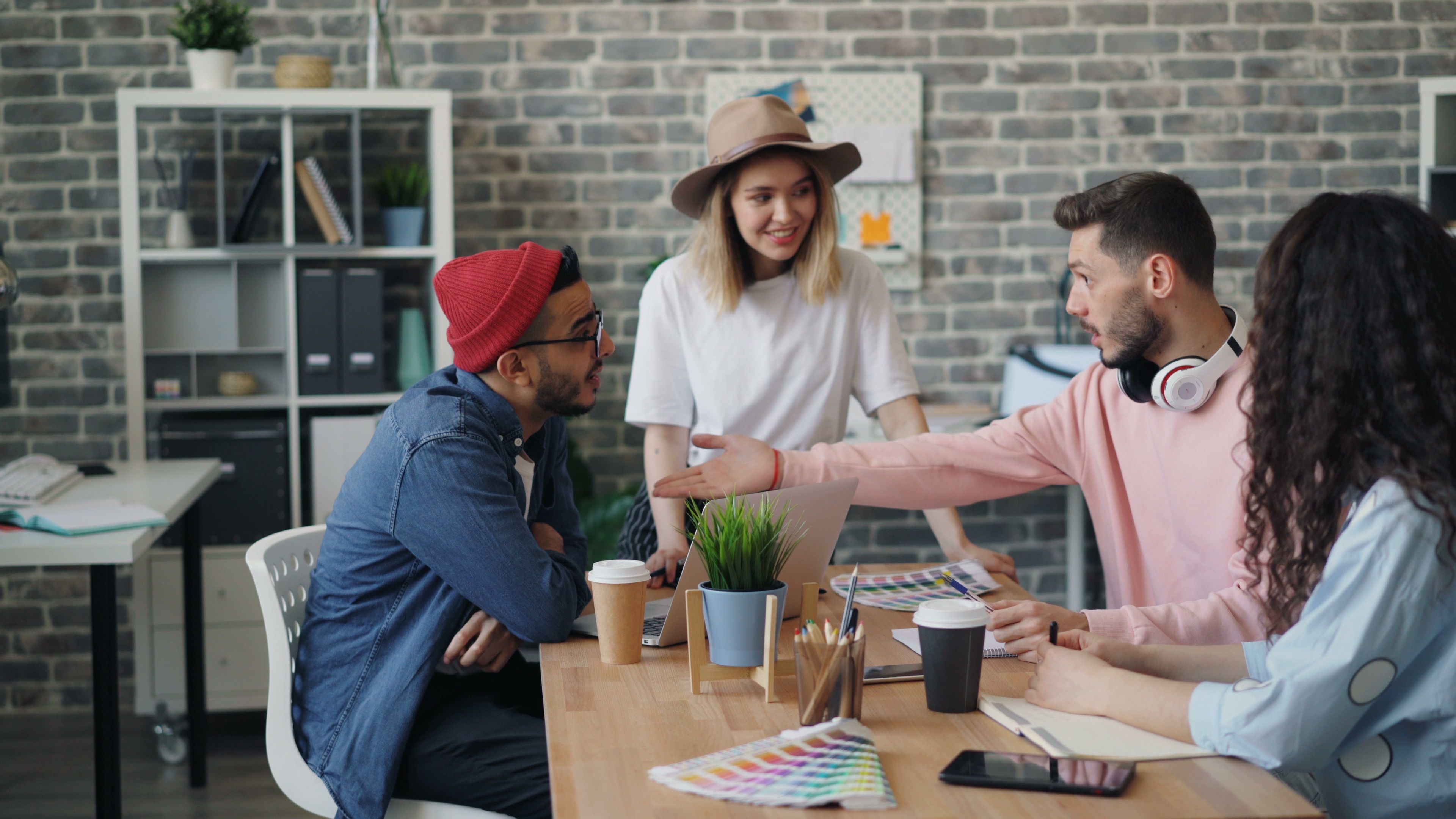 Group of people talking around a table in an office